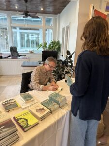 Author David Gessner signs copies of his book A Travelers Guide to the End of the World